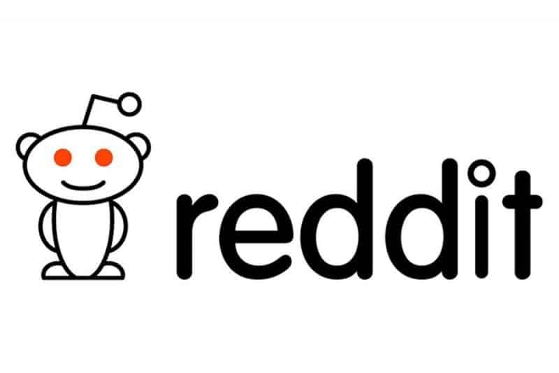 Logo of Reddit featuring a stylized white cartoon figure with an antenna and red eyes, next to the lowercase text "We are now on Reddit" in black.