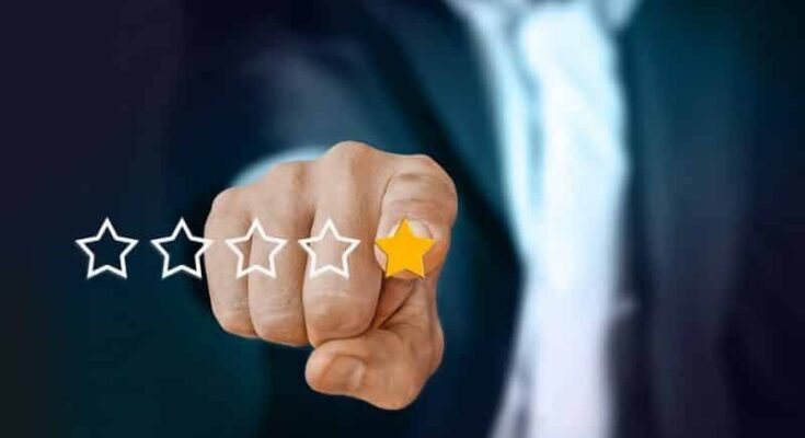 A person's fist with stars, symbolizing the power and impact of reviews in online business success.