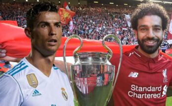 Two men holding the Champions League trophy.