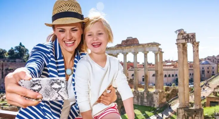 A woman and child taking a selfie using A.I. technology.