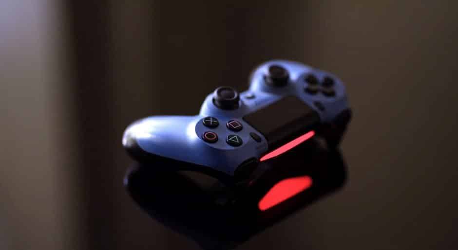 A close-up image of a video game controller highlighting illuminated buttons and joysticks against a dark, reflective background, promoting free games.