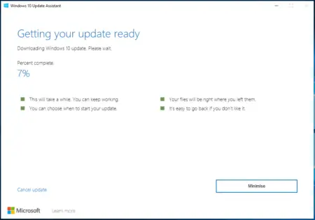 Screenshot of the Windows 10 Update Assistant showing a progress bar at 7% completion for manually updating to Windows 1903, with options to cancel, minimize, and learn more.
