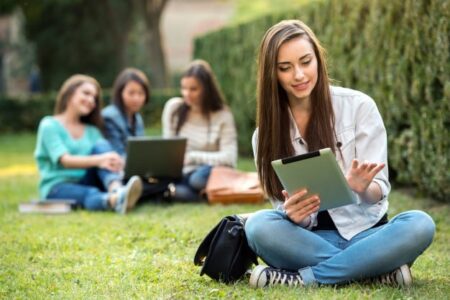 smiling-college-girl-is-holding-tablet-pc