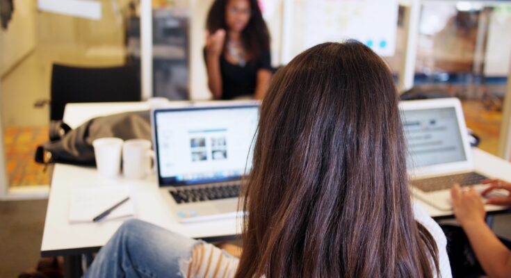 Technology Company Women sitting by laptops