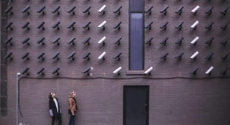 two-person-standing-under-lot-of-bullet-cctv-camera