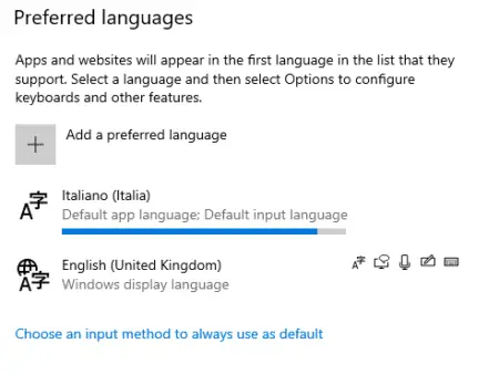 Screenshot of a computer settings window displaying options for Windows 10 language packs, with Italian (Italia) set as the default app and input language, and English (United Kingdom) as