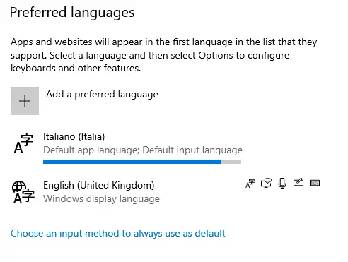 Screenshot of a computer settings window displaying options for Windows 10 language packs, with Italian (Italia) set as the default app and input language, and English (United Kingdom) as