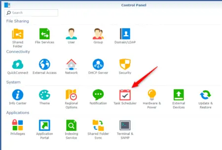 Screenshot of a Synology computer's control panel interface highlighting the "task scheduler" icon with a red arrow. Icons for various system settings and features are visible.