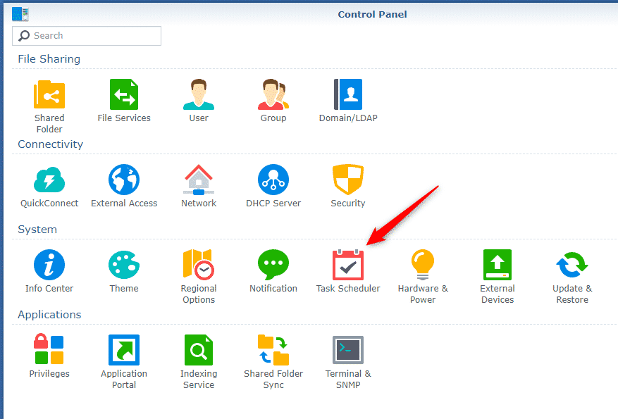 Screenshot of a Synology computer's control panel interface highlighting the "task scheduler" icon with a red arrow. Icons for various system settings and features are visible.