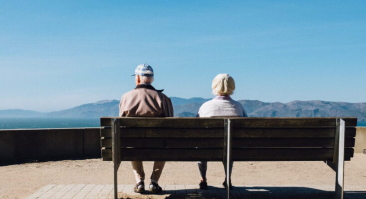 elderly couple sat down on a bench