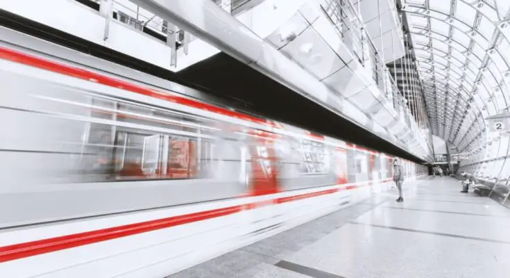 blurred motion of illuminated railroad station in city