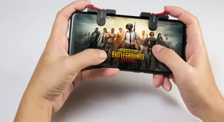 Hand holding a smartphone with Player's Unknown Battleground also known as PUBG online shooting gaming