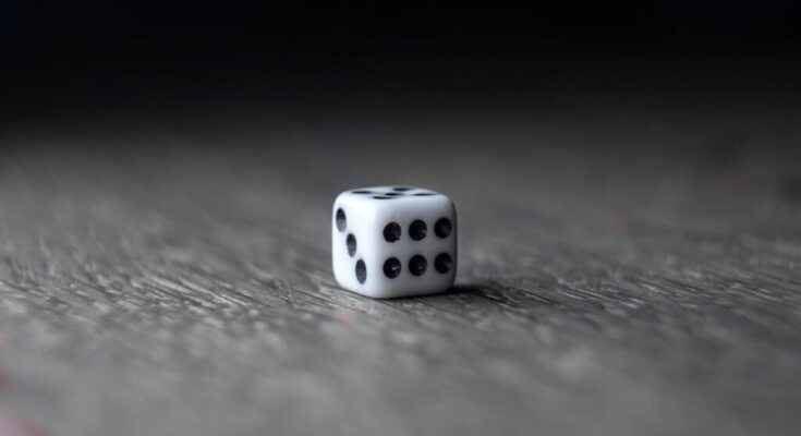 small white dice placed on wooden table