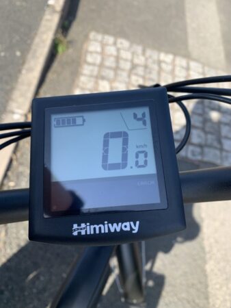 An electronic display on a Himiway City Pedelec bicycle handlebar showing an error message, the speed at 0 km/h, and a low battery indicator. The brand "Himiway