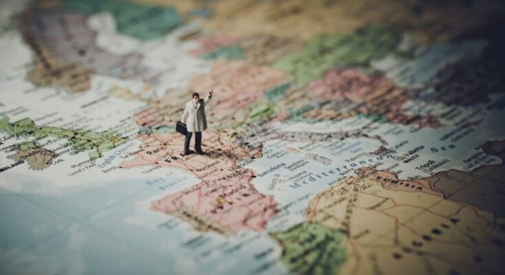 model figure standing on map