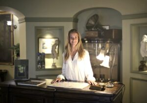 hospitable woman at reception of antique hotel