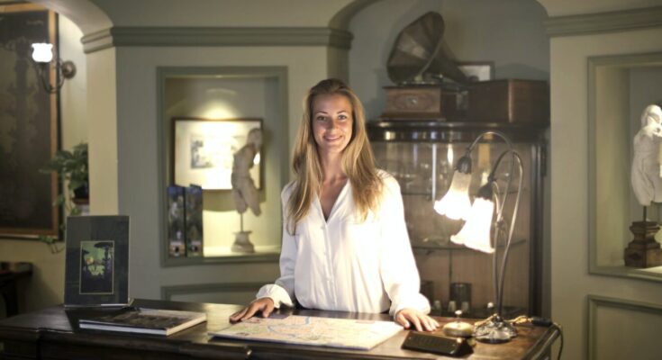 hospitable woman at reception of antique hotel