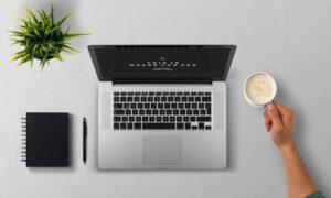 man using laptop on table against white background