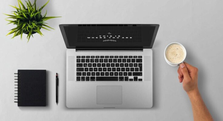 man using laptop on table against white background