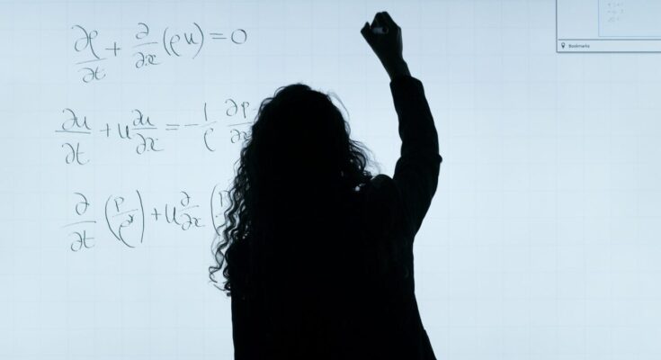 woman writing on a whiteboard