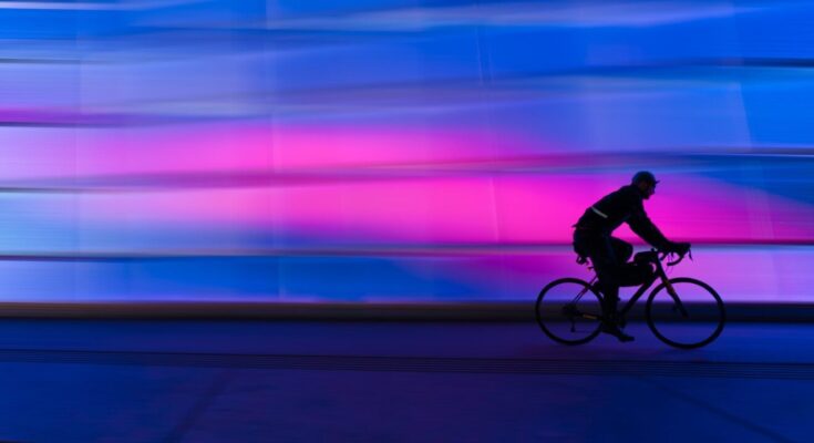 silhouette of person riding on commuter bike