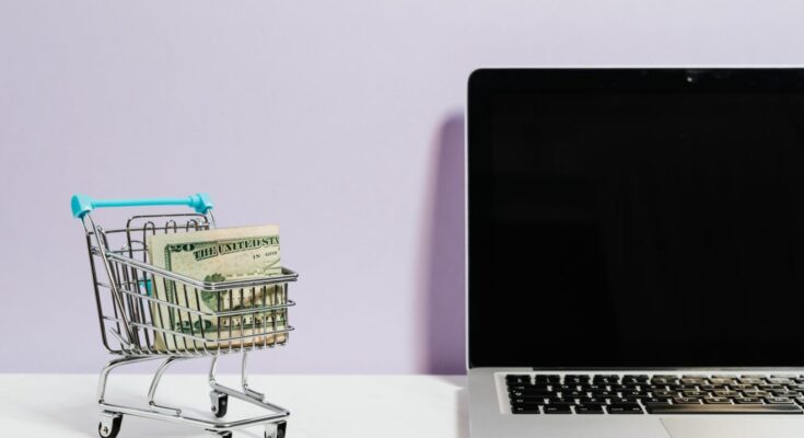 shopping cart next to a laptop