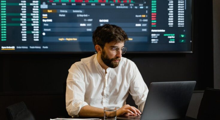 man in white dress shirt using black laptop computer