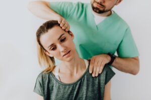 professional massage therapist treating a female patient s injured neck