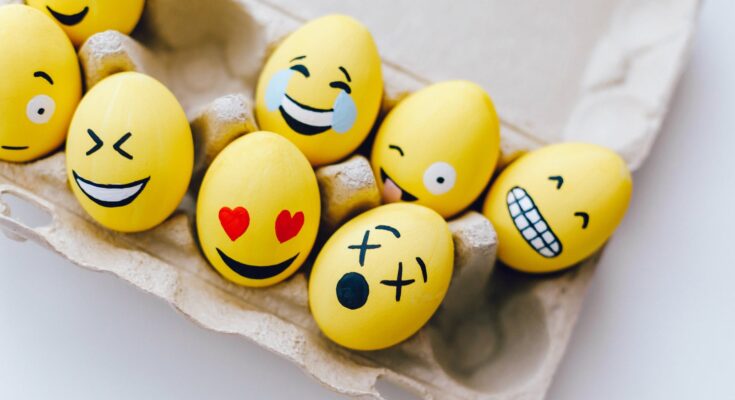 yellow painted eggs with various facial expressions