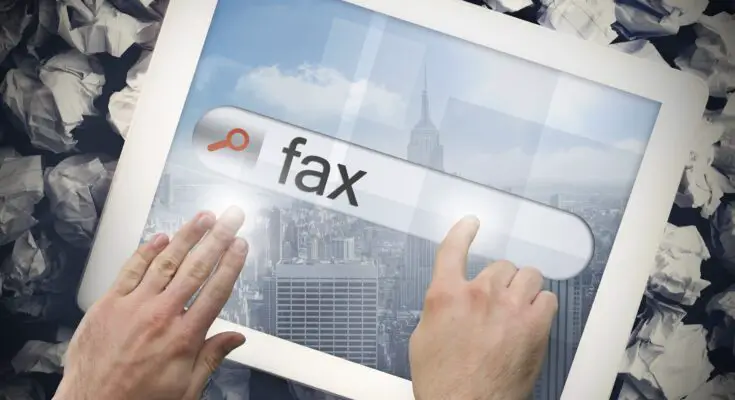 Hand touching fax on search bar on tablet screen