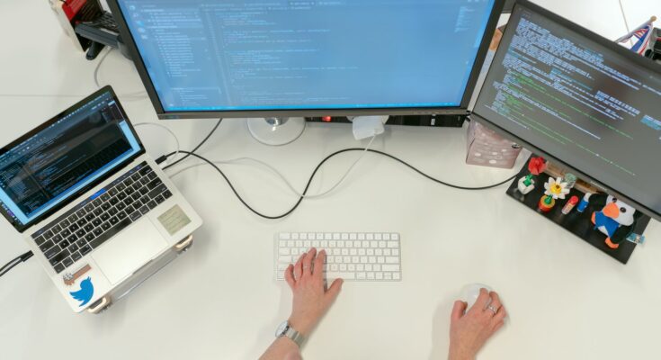 female software engineer coding on computer