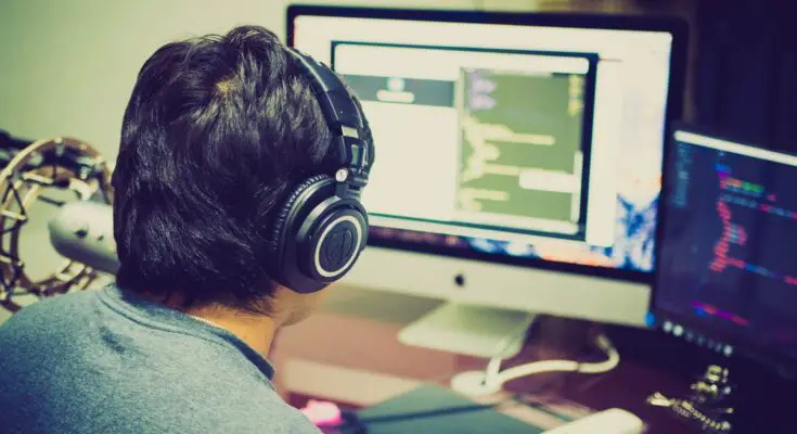 selective focus photography of man facing computer