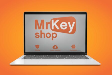 A laptop screen displaying the Windows 11 logo of "mrkeyshop" with icons for security, instant download, and saving money, set against a vibrant orange background.