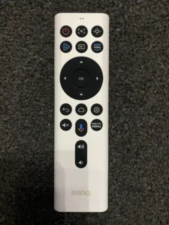 White BenQ GV30 remote control with multiple buttons including power, volume, and navigation controls, along with dedicated buttons for apps like Prime Video.