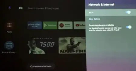 Smart tv screen displaying various streaming applications including amazon prime video and features thumbnails for movies "7500" and "man on fire", and wi-fi & internet settings menu on the right side, with a
