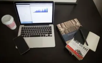 laptop with books around it