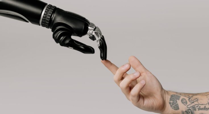 bionic hand and human hand finger pointing