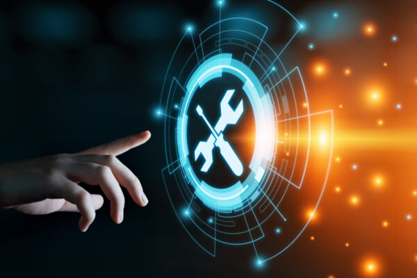 A human finger interacts with a futuristic digital interface displaying a holographic wrench symbol, set against a dark background with glowing orange lights, indicating tech support functions.