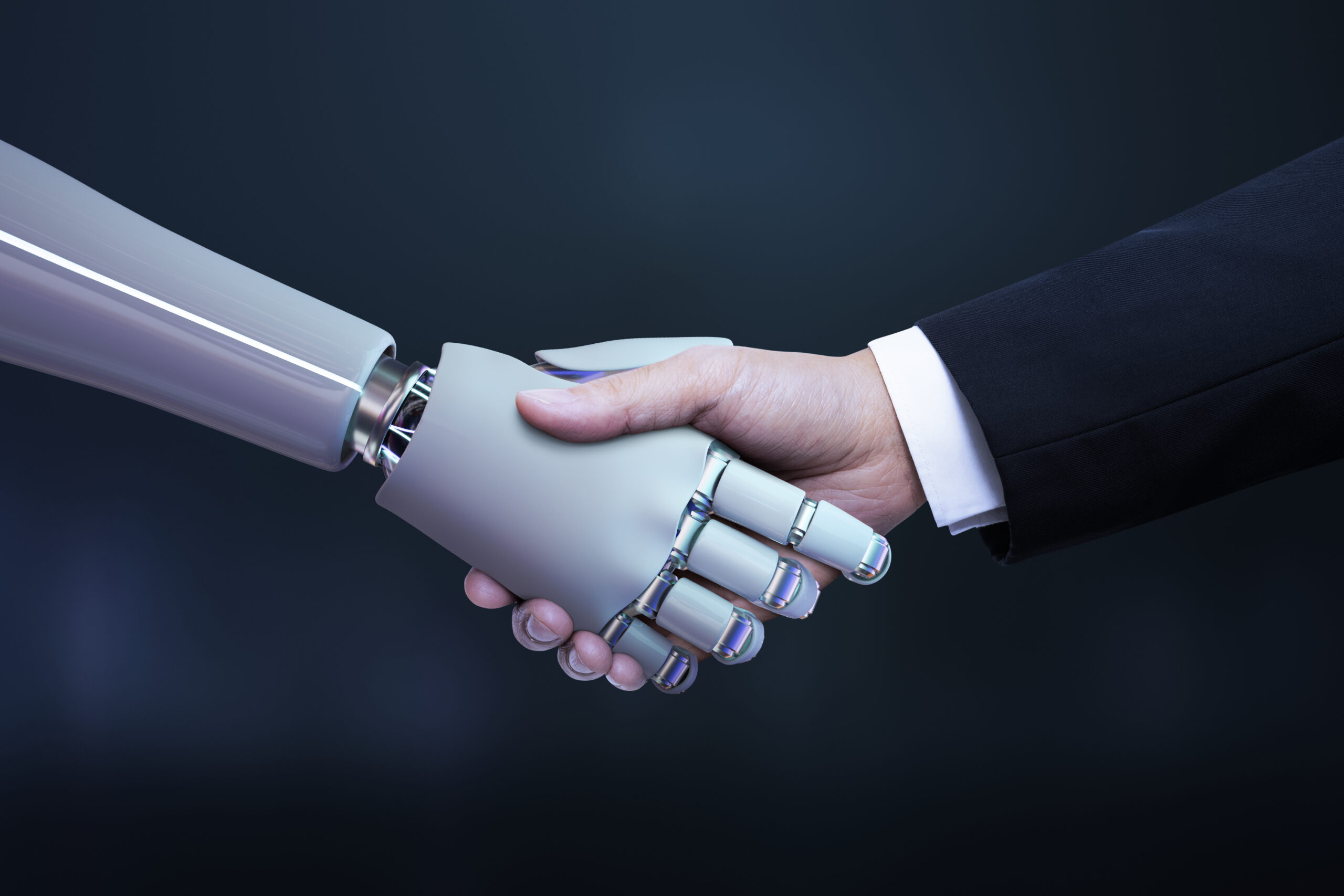 A robotic hand shaking hands with a human hand, symbolizing the intersection of AI solutions and human interaction against a dark background.