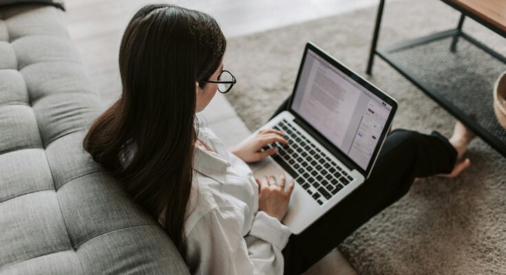 Woman Working At Home Using Her Laptop