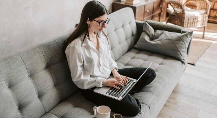 Woman Working At Home Using Laptop